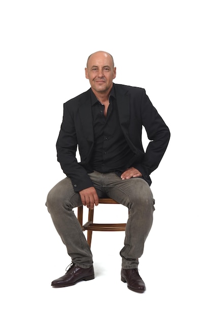 Front view of a bald man sitting on chair on white background