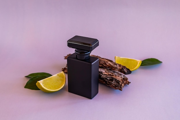 Front view of a black bottle of men's perfume or toilet water with the aroma of natural ingredients a template for perfume