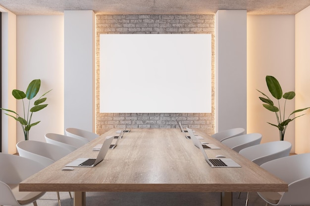 Front view on blank white poster on brick wall in stylish board room with wooden meeting table with modern laptops surrounded by white chairs and green plants 3D rendering mock up