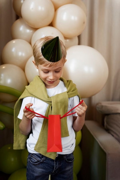 Front view boy opening birthday gift