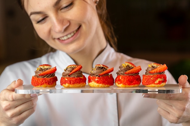 Front view of chef looking at a plate with food