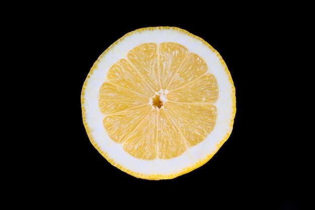 Front view close up photo of half a lemon on a black background