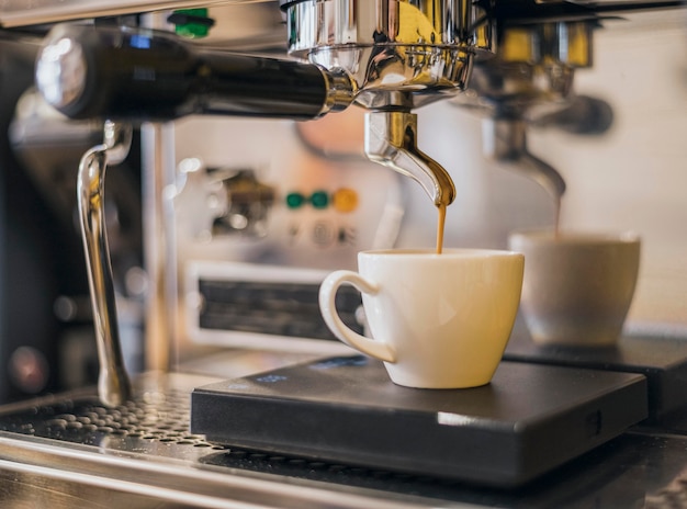 Front view of coffee machine making coffee