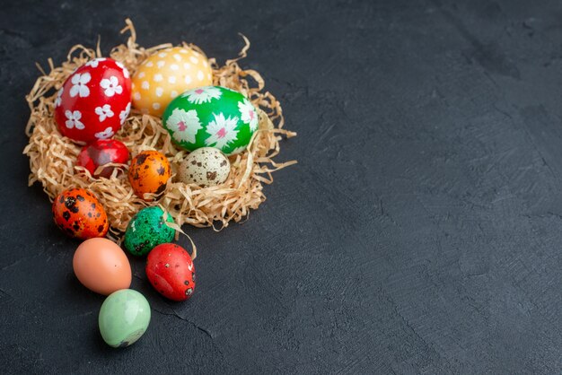 front view colored designed eggs on straw dark background holiday ornate horizontal concept colourful spring novruz