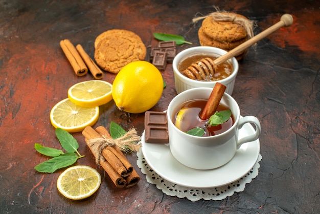 front view cup of tea with biscuits on dark background color morning sweet breakfast fruit ceremony tea cookie