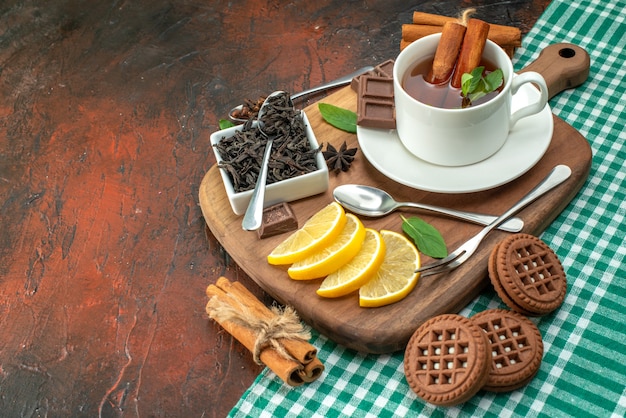 front view cup of tea with biscuits and lemon on dark background flower photo color cookie tea coffee flavor