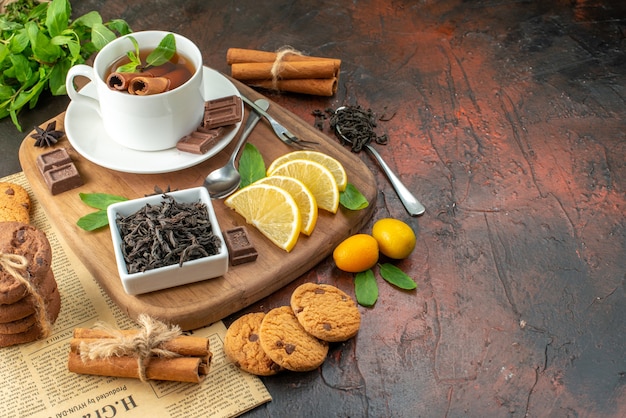 front view cup of tea with chocolate and lemon slices on dark background breakfast ceremony sweet cocoa tea fruit color free space