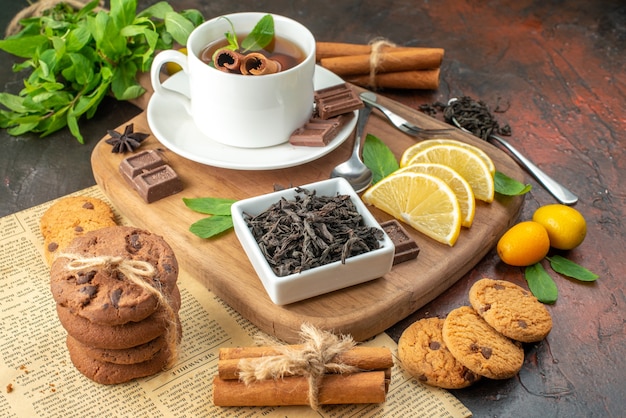 front view cup of tea with chocolate and lemon slices on dark background breakfast ceremony sweet cocoa tea fruit color