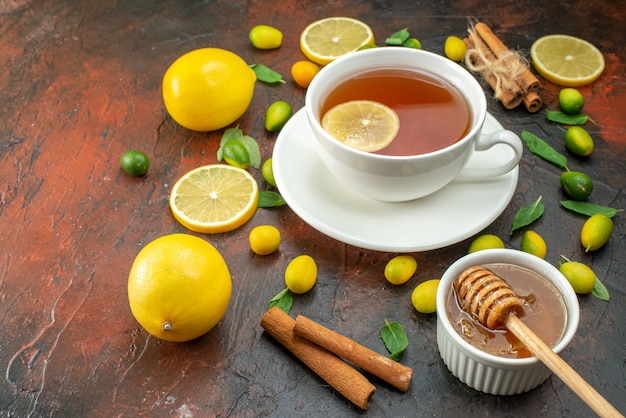 front view cup of tea with fresh yellow lemons on dark brown background color ceremony tea breakfast fruit morning break coffee