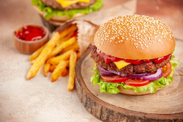 Front view delicious cheeseburgers with french fries on cutting board on a light background salad fast-food potato sandwich burger snack