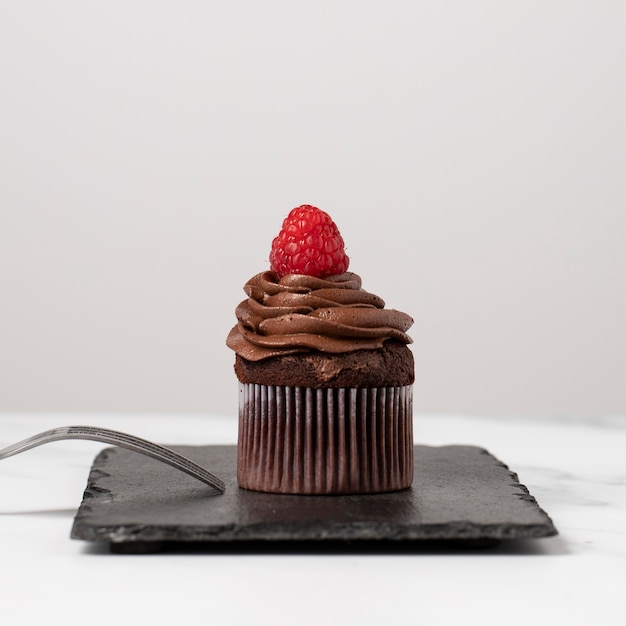 Front view of delicious chocolate cupcakes with raspberry