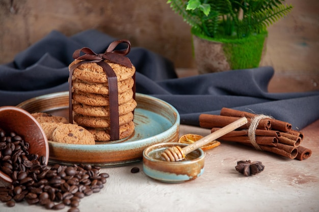 Front view delicious cookies with cup of coffee on light surface dessert sweet cake tea dough sugar biscuit