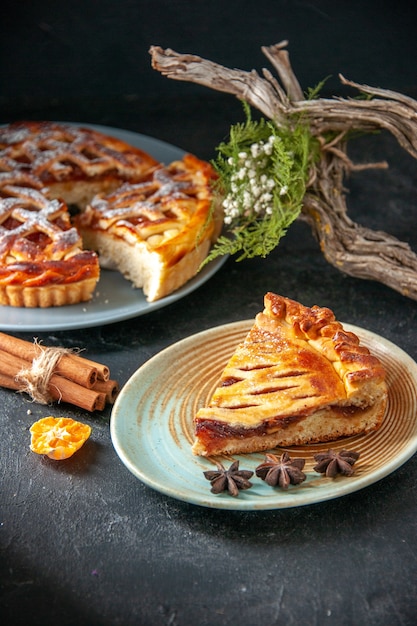 front view delicious fruity pie with jelly on the dark background biscuit dough sweet pie oven dessert bake sugar cake