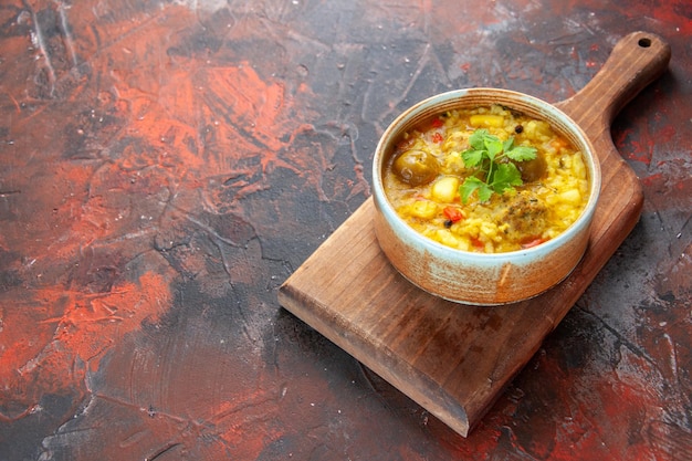 Front view delicious meat soup inside little plate on cutting board dark