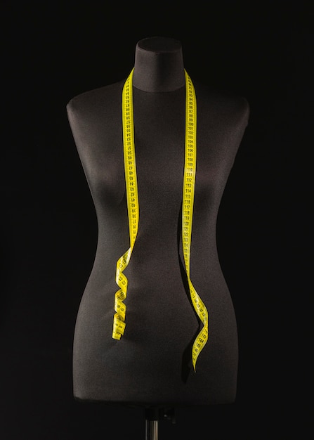 Front view of dress form with measuring tape