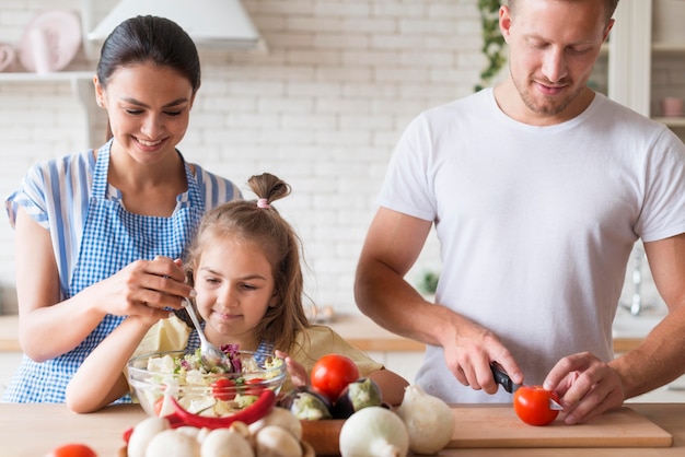 Front view family cooking together