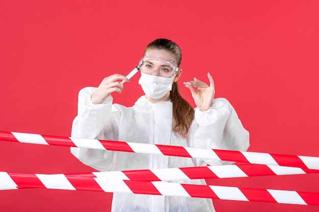 front view female doctor in protective suit making injection on red background crime covid- health cure nurse emotion hospital line