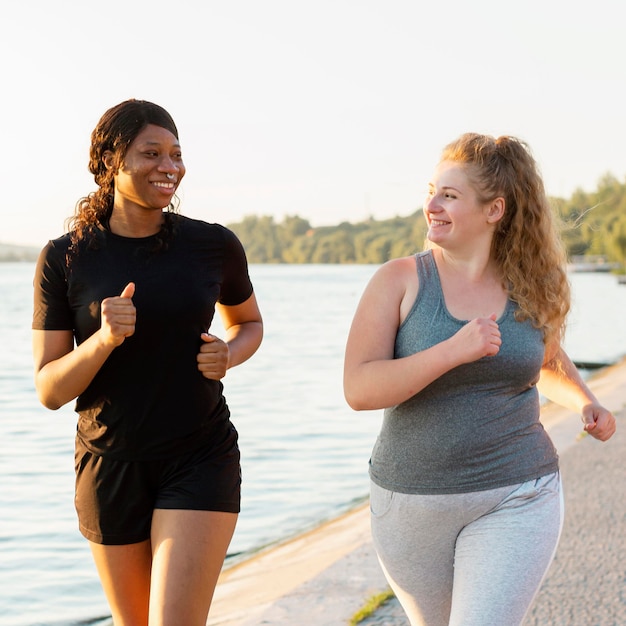 Front view of female friends jogging together