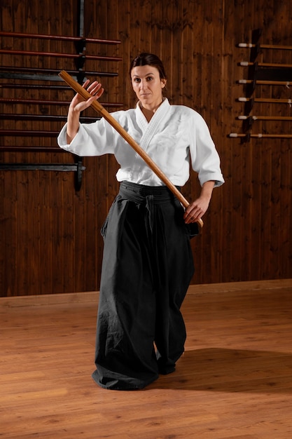 Front view of female martial arts trainee in the practice hall