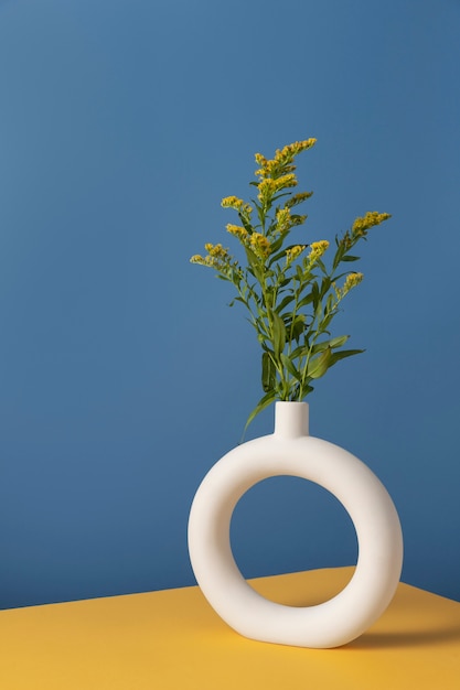 Front view of flower decor in a circle-shaped vase with copy space