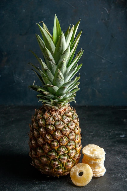 front view fresh pineapple dry pineapple slices on black background