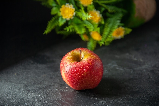 front view fresh red apple with green plant on dark background ripe color photo tree fruit mellow