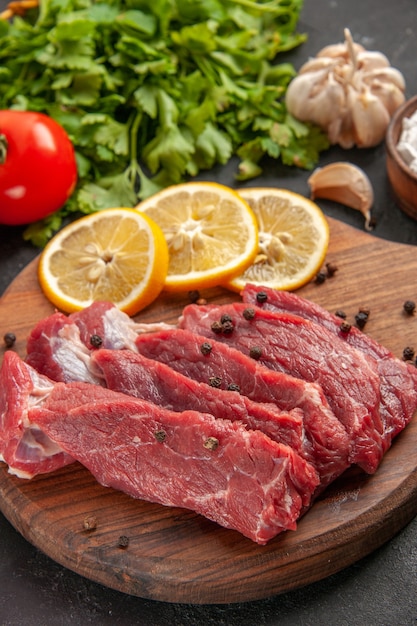 front view fresh red tomatoes with greens lemon and seasonings on dark background meal dinner meat animal food butcher salad barbecue