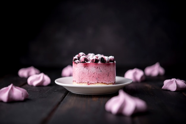 Front view of fruit cake with meringues