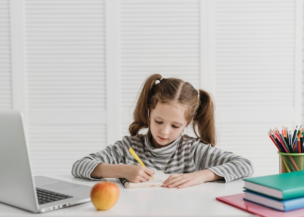 Front view girl learning from online classes