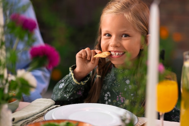 Front view girl sitting at table