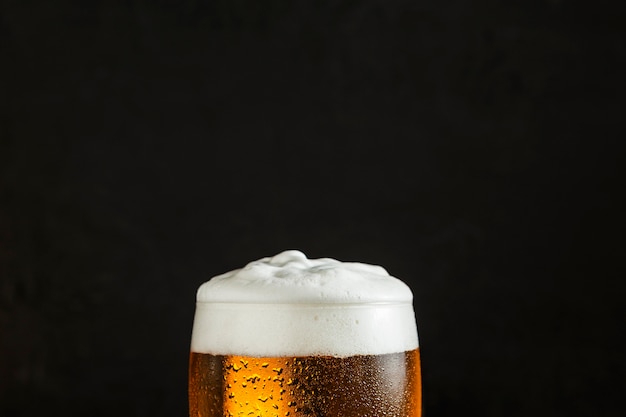 Front view of glass of beer with copy space