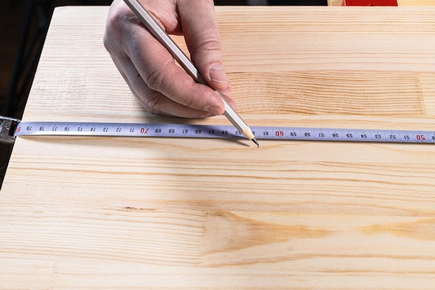 Front view of hand of carpenter with pencil