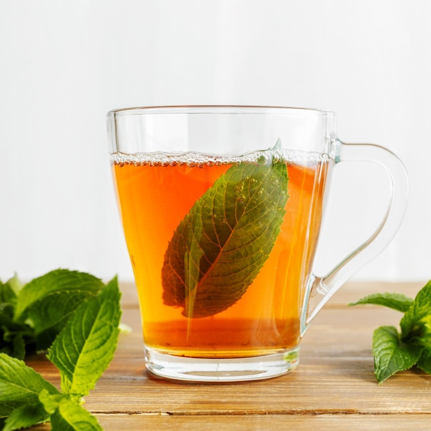 Front view of herbal tea concept on wooden table