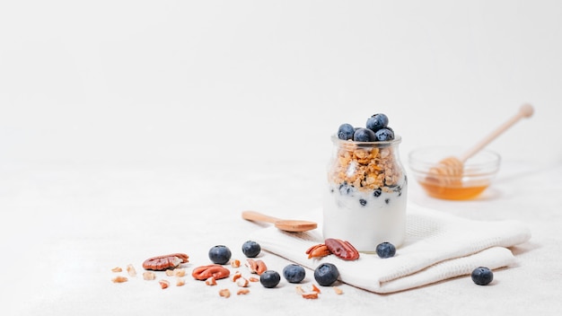 Front view jar filled with milk and fruits