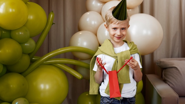 Front view kid opening birthday gift