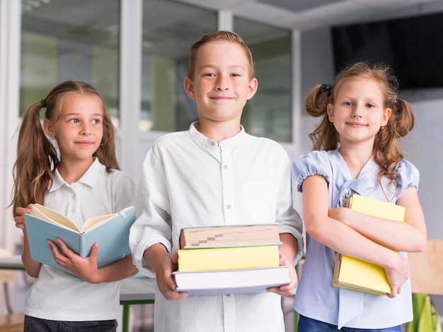 Front view kids holding books in class