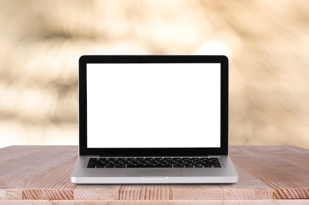 Front view of the laptop is on the work table with bokeh green background