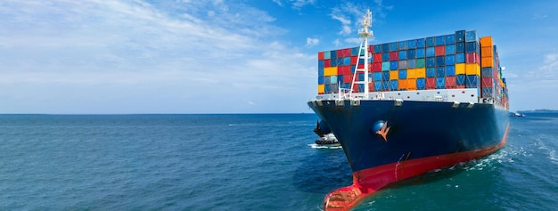 In Front View of large cargo ship import export container box on the ocean sea on blue sky back ground concept transportation logistic and service to customer and supply change forwarder mast