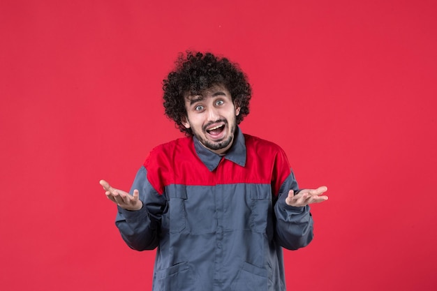 Front view male worker in uniform on red