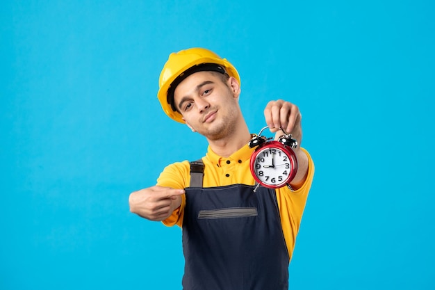 Front view of male worker in uniform with clocks on blue 