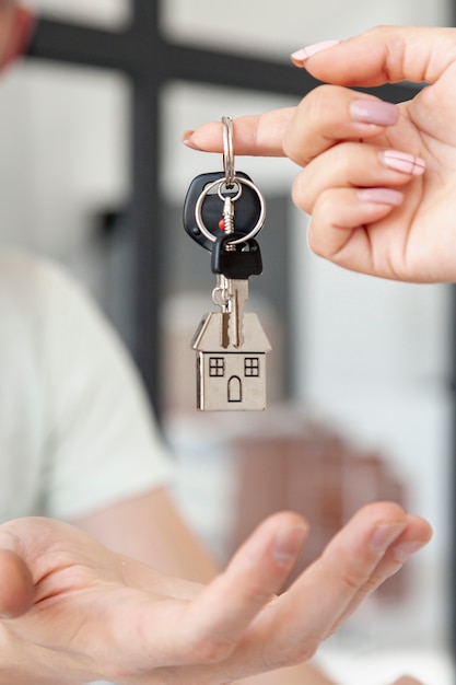 Front view man accepting the keys for a new house close-up