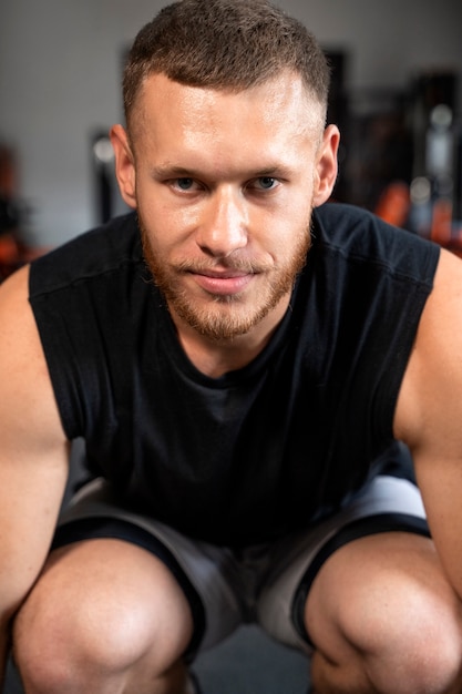 Front view man exercising at gym