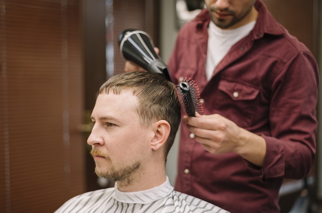 Front view of man having his hair dryed