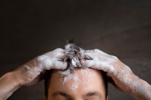 Front view man washing hair