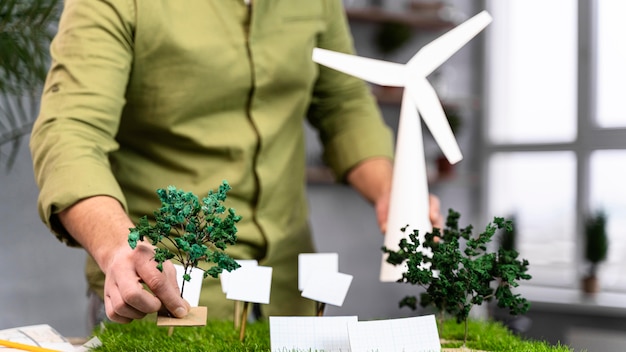 Front view of man working on an eco-friendly wind power project layout