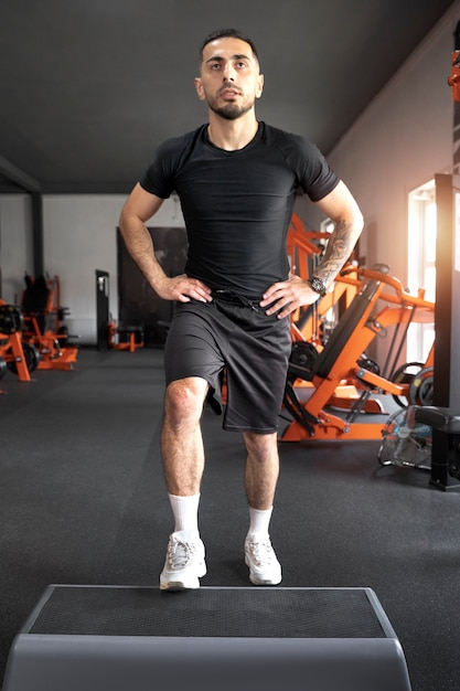 Front view man working out at gym