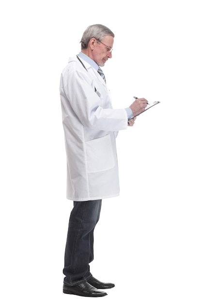 Front view of mature thoughtful doctor writing on clipboard