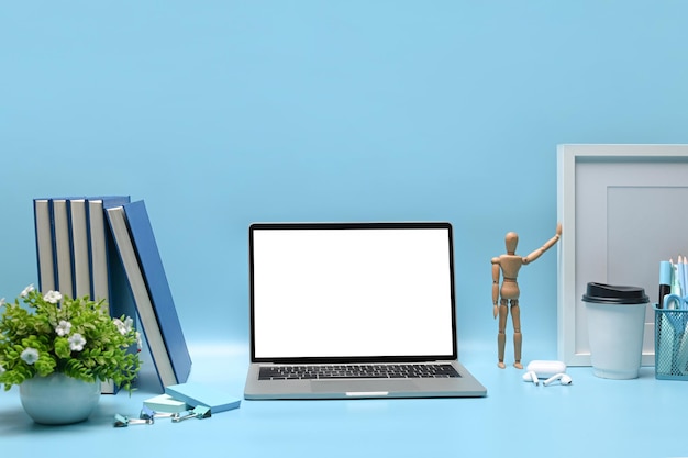 Front view mock up laptop and equipment on blue background