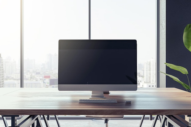 Front view of a modern office workplace with wooden desk with blank screen computer on city view window background in cozy interior mockup Comfortable and ergonomic workspace concept 3D Rendering