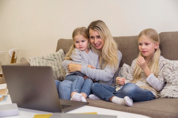 Front view of mom and daughters with technology